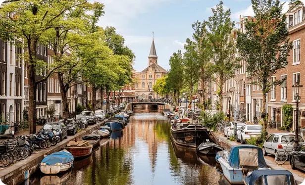 Amsterdam canal with boats and bridges, home of The Rage Room Amsterdam
